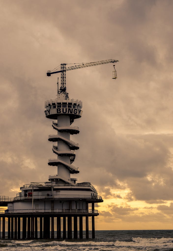 Dramatic capture of Scheveningen Pier amidst a moody sky over the North Sea.